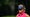 dottie pepper stares in blue hat and pink shirt at at the PGA Championship with headset on.