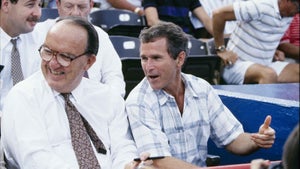 MLB Commissioner Fay Vincent and Texas Rangers managing general partner George W. Bush look on during a July 1990 Texas Rangers game at Arlington Stadium in Arlington, Texas