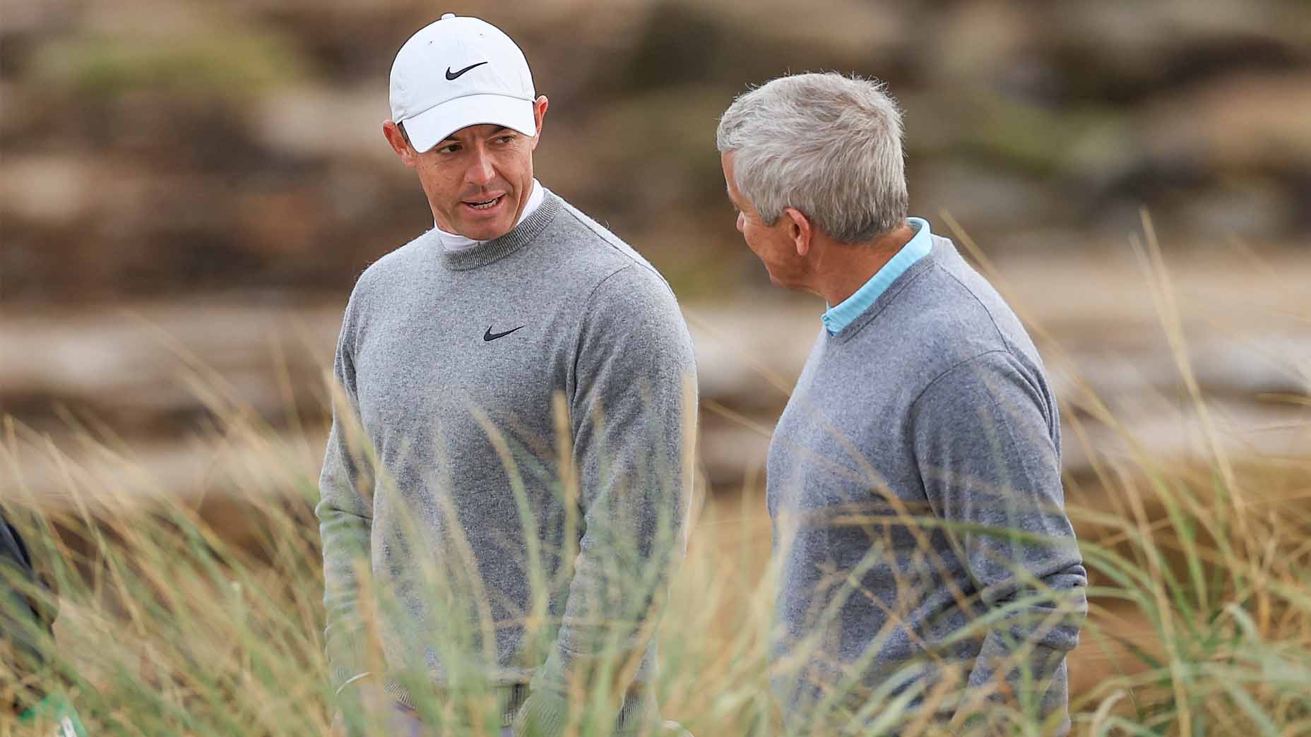 Rory McIlroy and PGA Tour commissioner Jay Monahan talk during the 2024 Alfred Dunhill Links Championship.