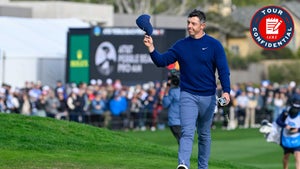 rory mcilroy waves hat at the AT&T Pebble Beach Pro-Am in navy sweater and blue pants.