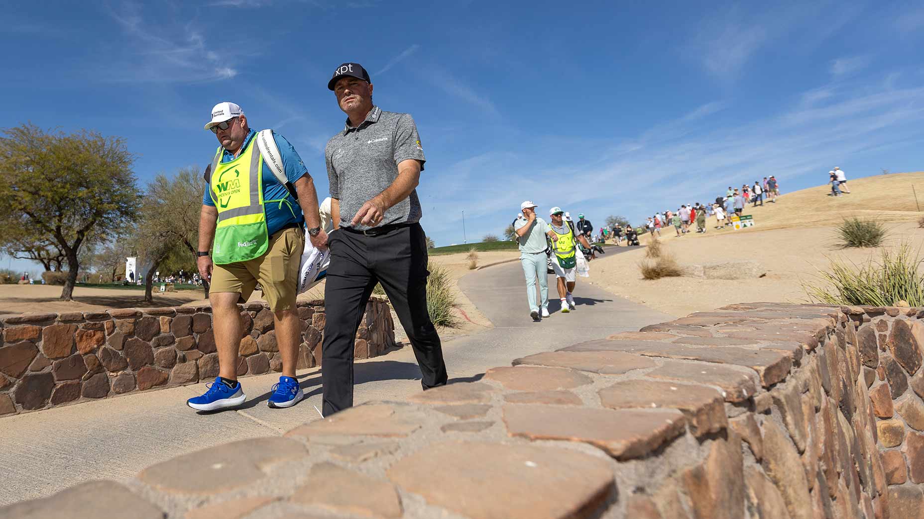 PGA Tour pro ryan palmer walks over a bridge at the wm phoenix open