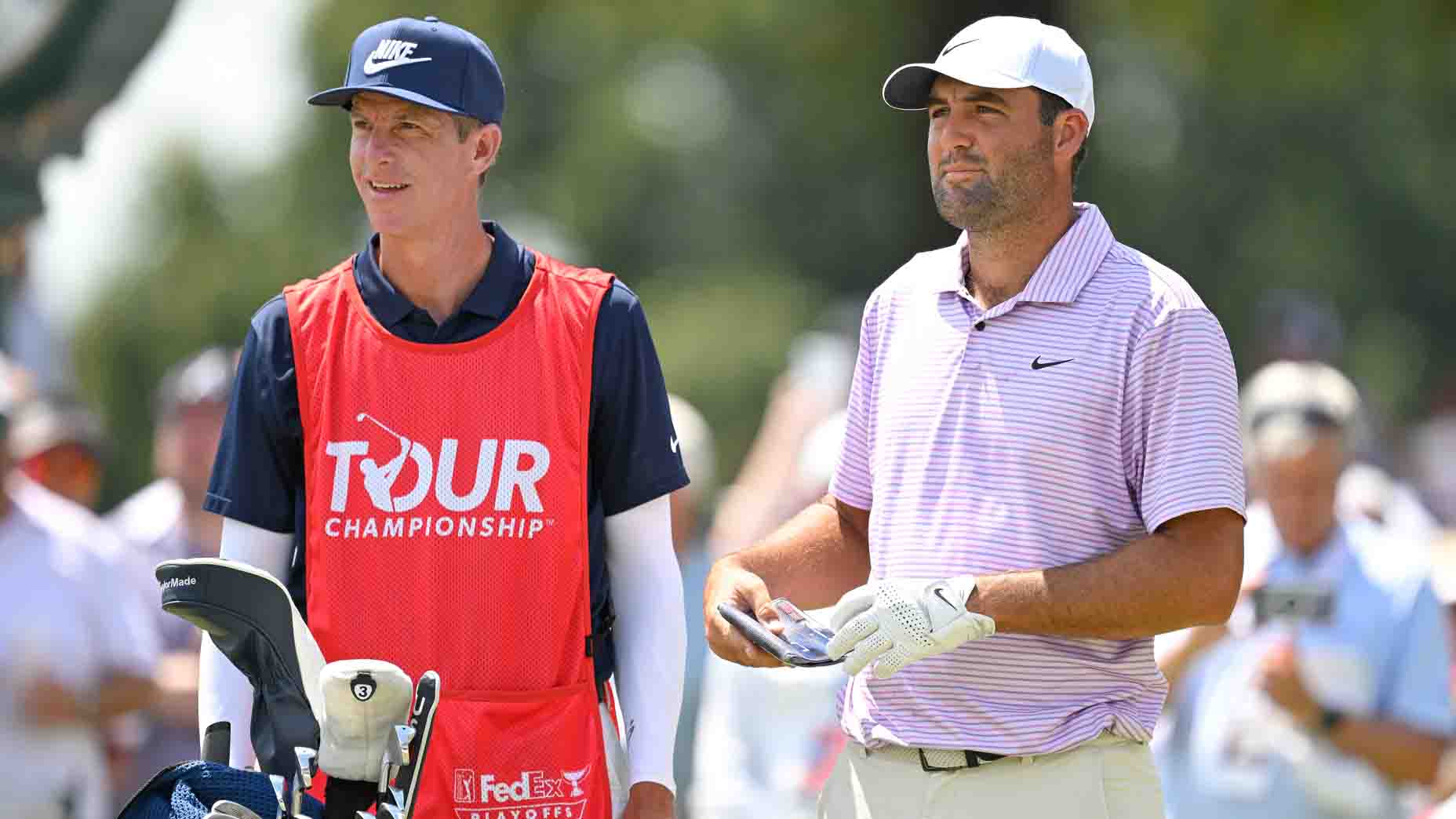 Scottie Scheffler and caddie Ted Scott look on during the 2025 Tour Championship.