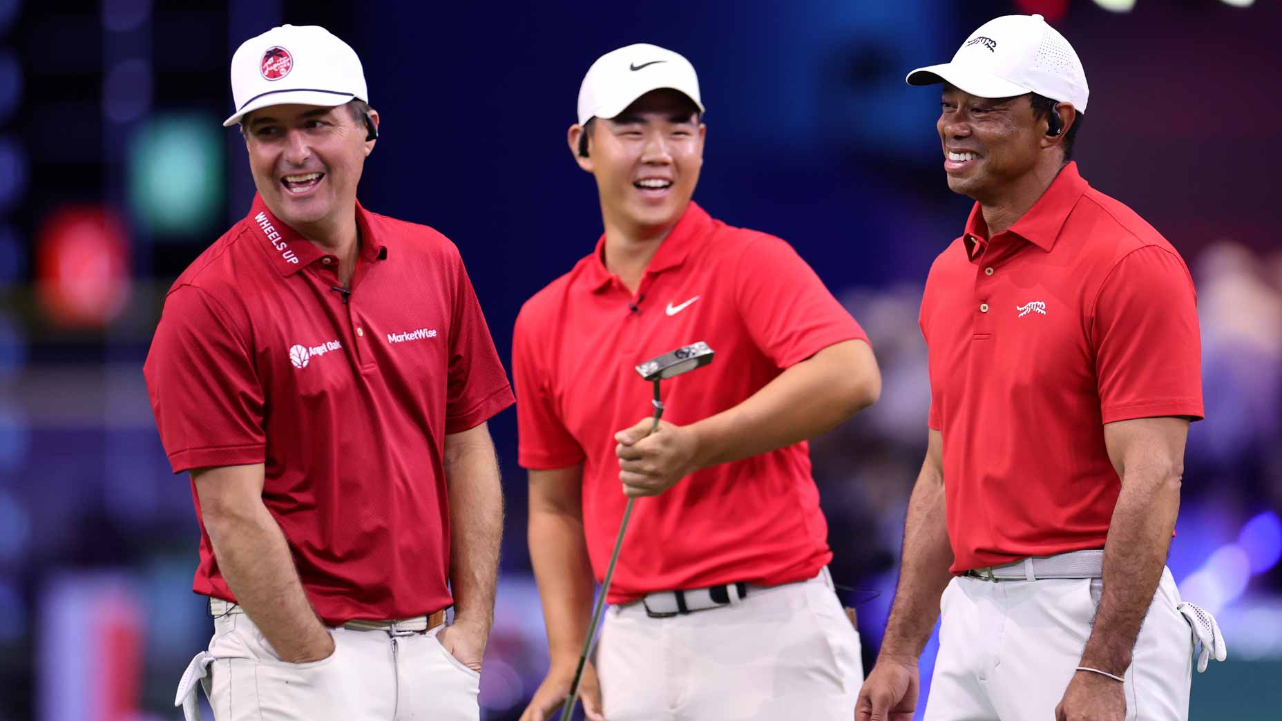 TGL pros Tiger Woods, Kevin Kisner and Tom Kim of Jupiter Links Golf Club react during their match against the Boston Common Golf.