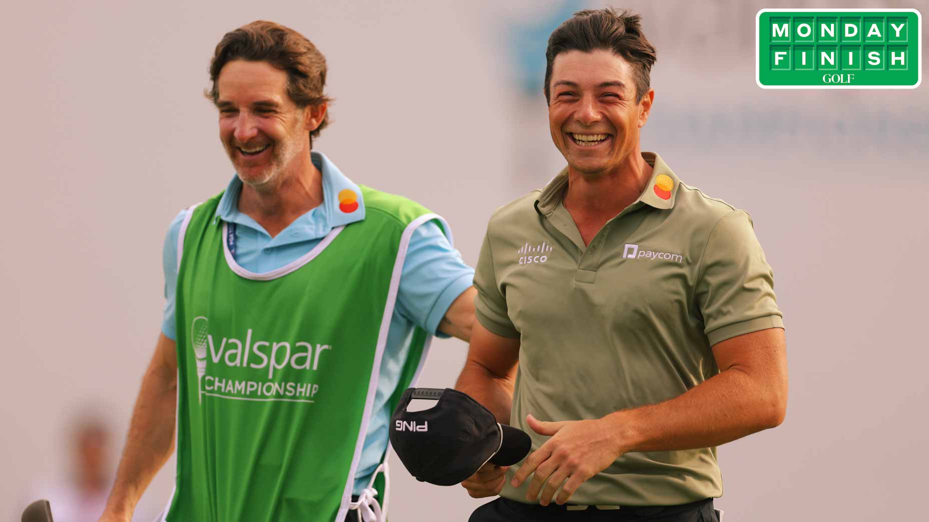 Viktor Hovland and his caddie Shay Knight walk off the 18th green at the Valspar Championship.