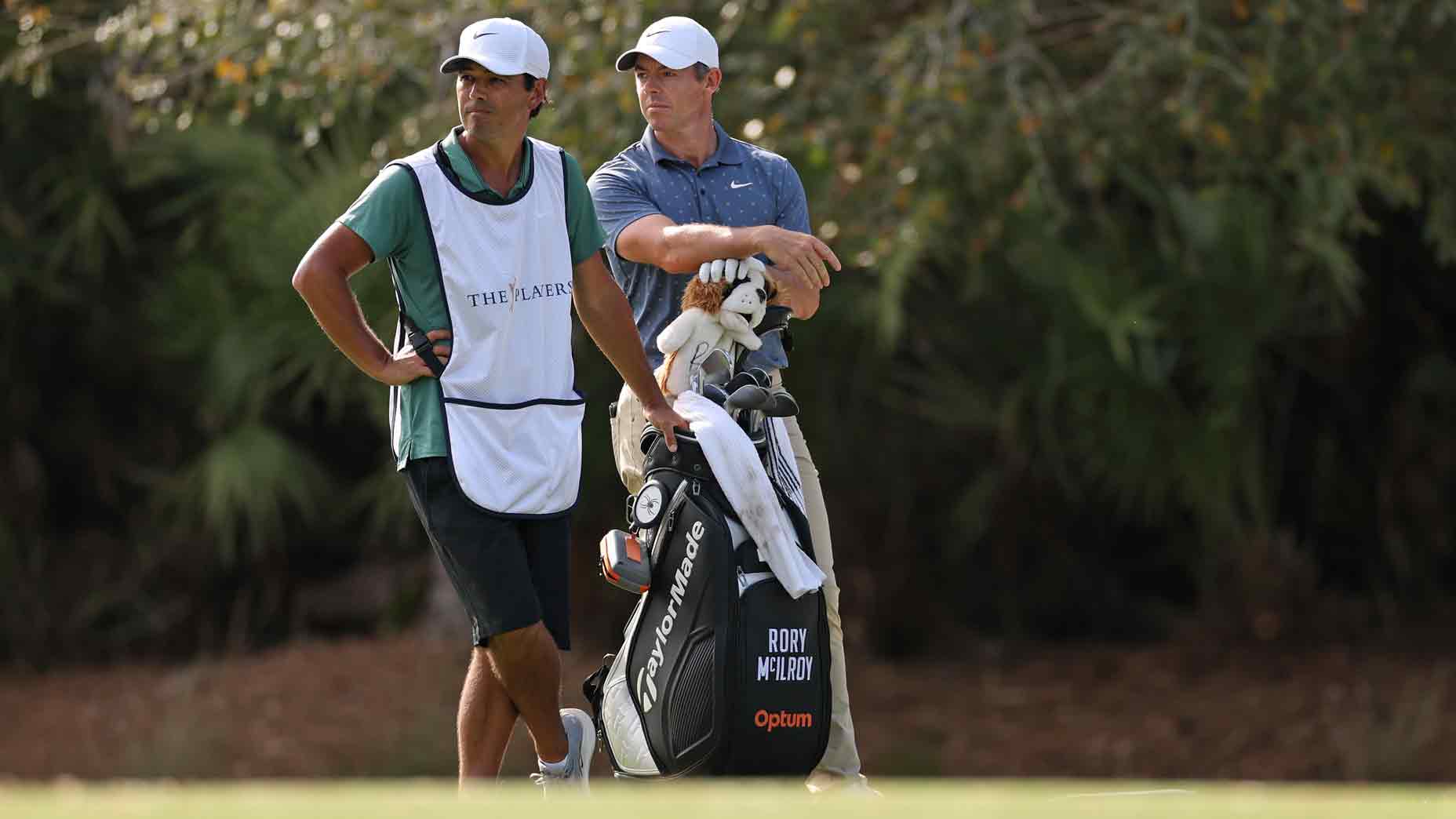 Rory Mcilroy from Northern Ireland and his caddy, Harry Diamond, watch from the ninth hole during the third round of the player championship at the TPC Sawgrass stadium on March 15, 2025 in Ponte Vedra Beach, Florida.