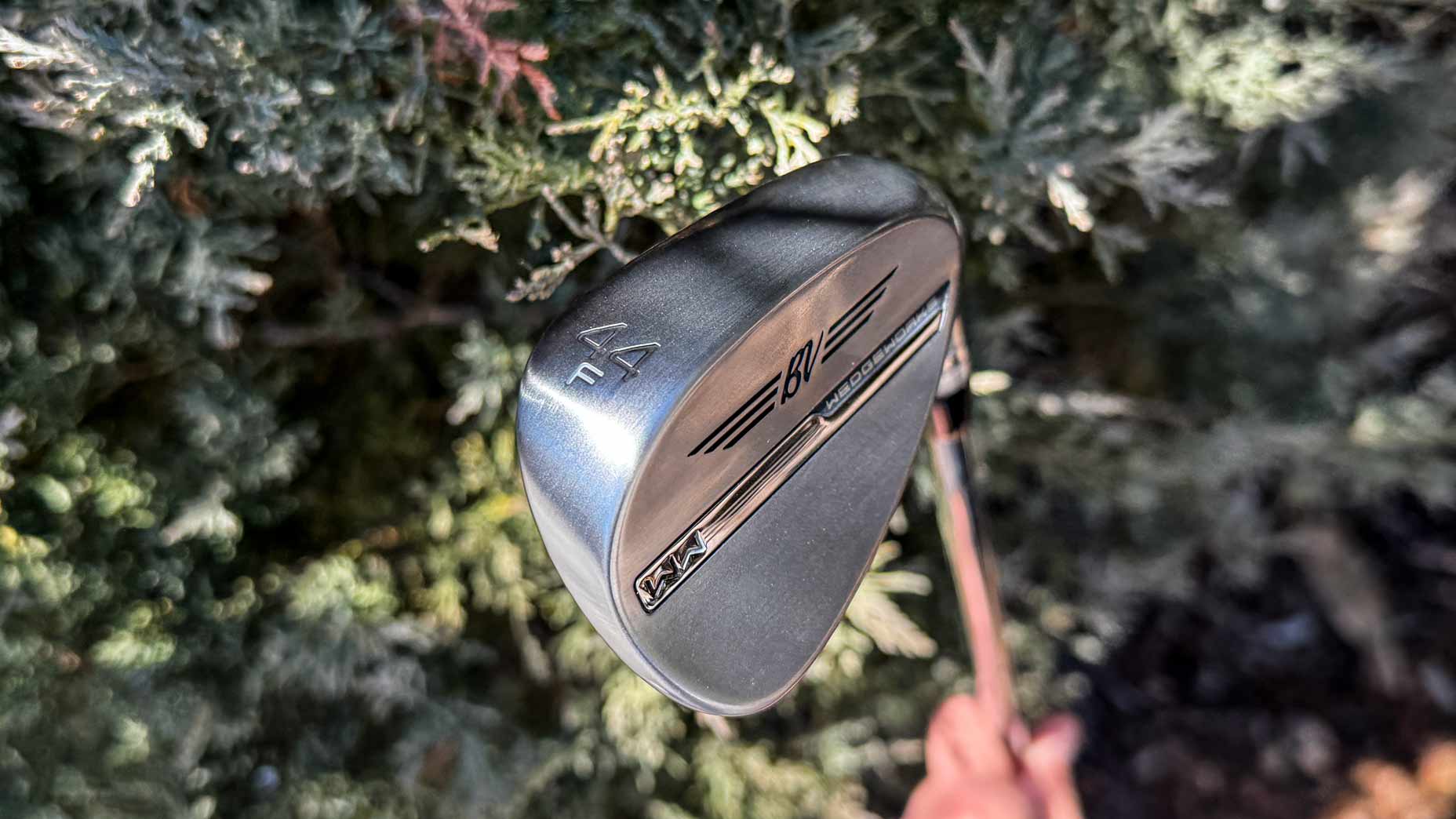 A Vokey WedgeWorks 44F Pitching Wedge in hand photo on golf course