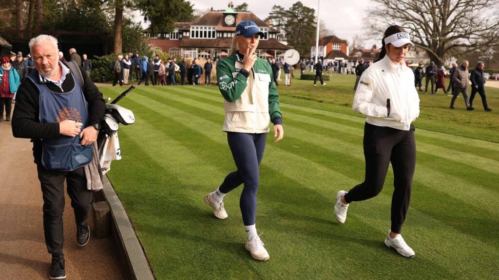 Charley Hull smokes a cigarette on the first tee during the first round of the 2025 Sunningdale Foursomes at Sunningdale Golf Club.