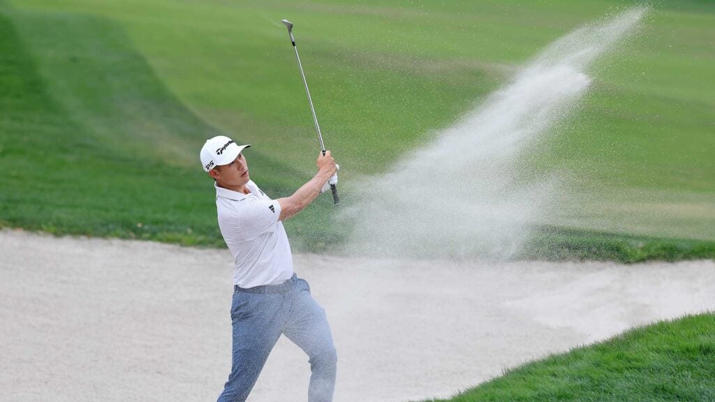 Collin Morikawa holes out from the bunker on the 1st hole during the final round of the Arnold Palmer Invitational on Sunday.