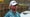 danny walker stands at island green 17th at the players championship in blue shirt and white hat