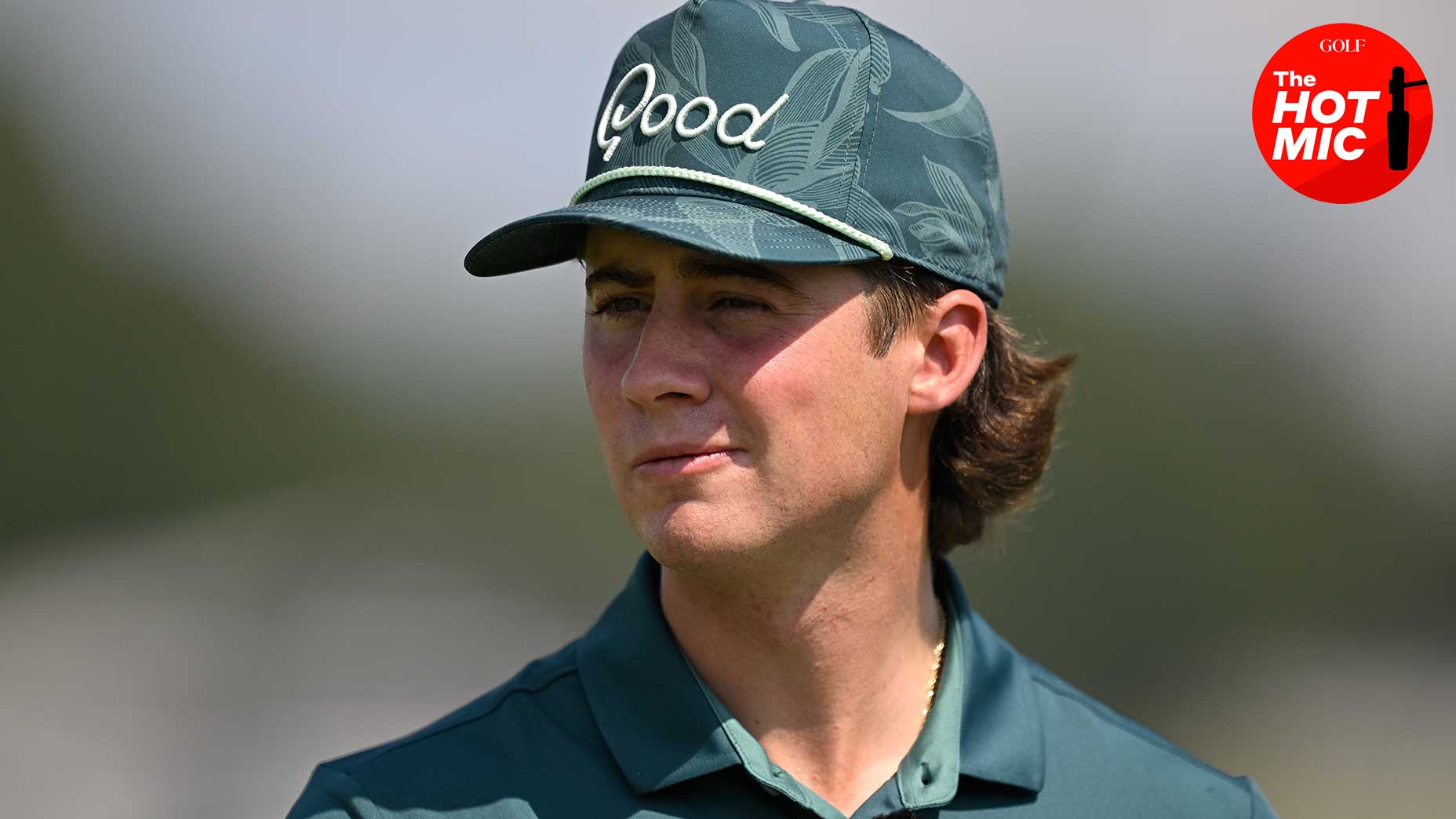 garrett clark smirks in green hat at the creator classic at the tour championship