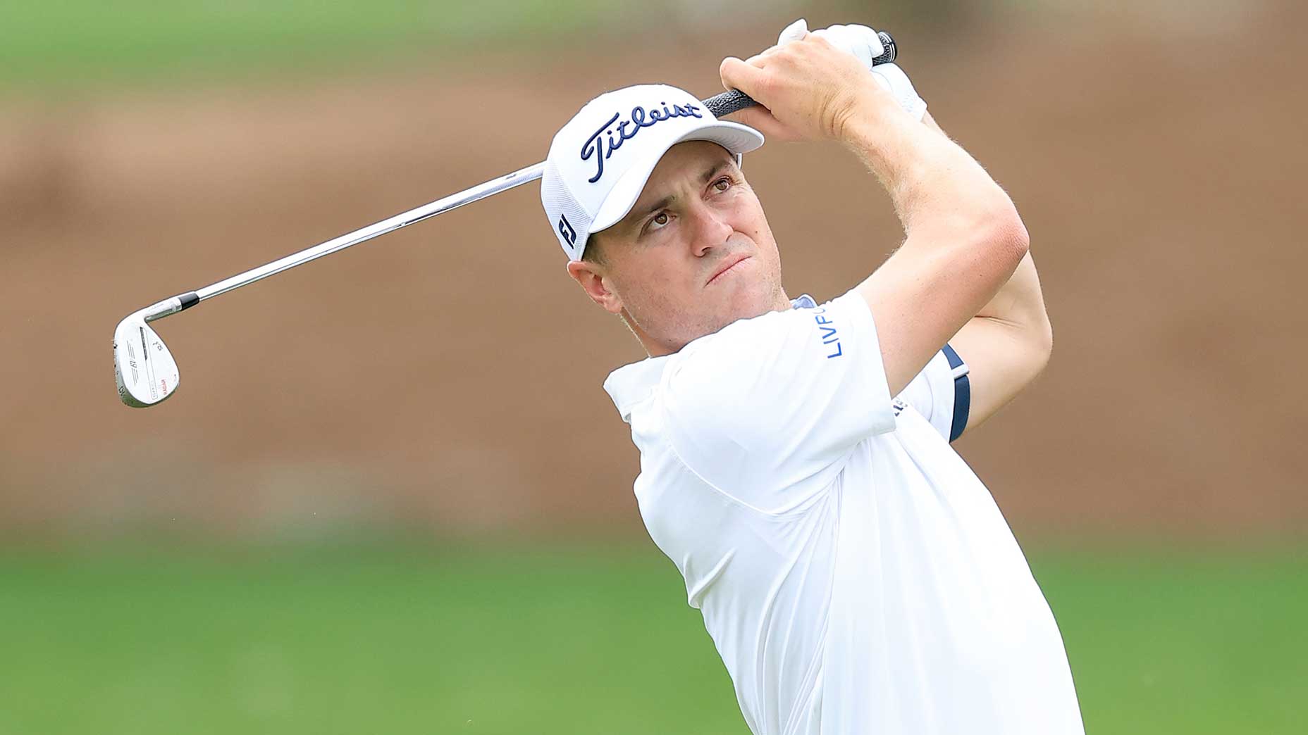 justin thomas watches an approach during a golf tournament