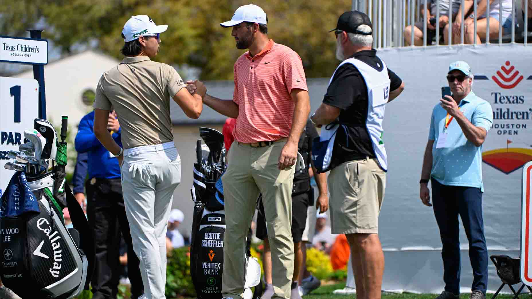 Scottie Scheffler and Min Woo Lee shake hands before the third round of the Texas Children's Houston Open.