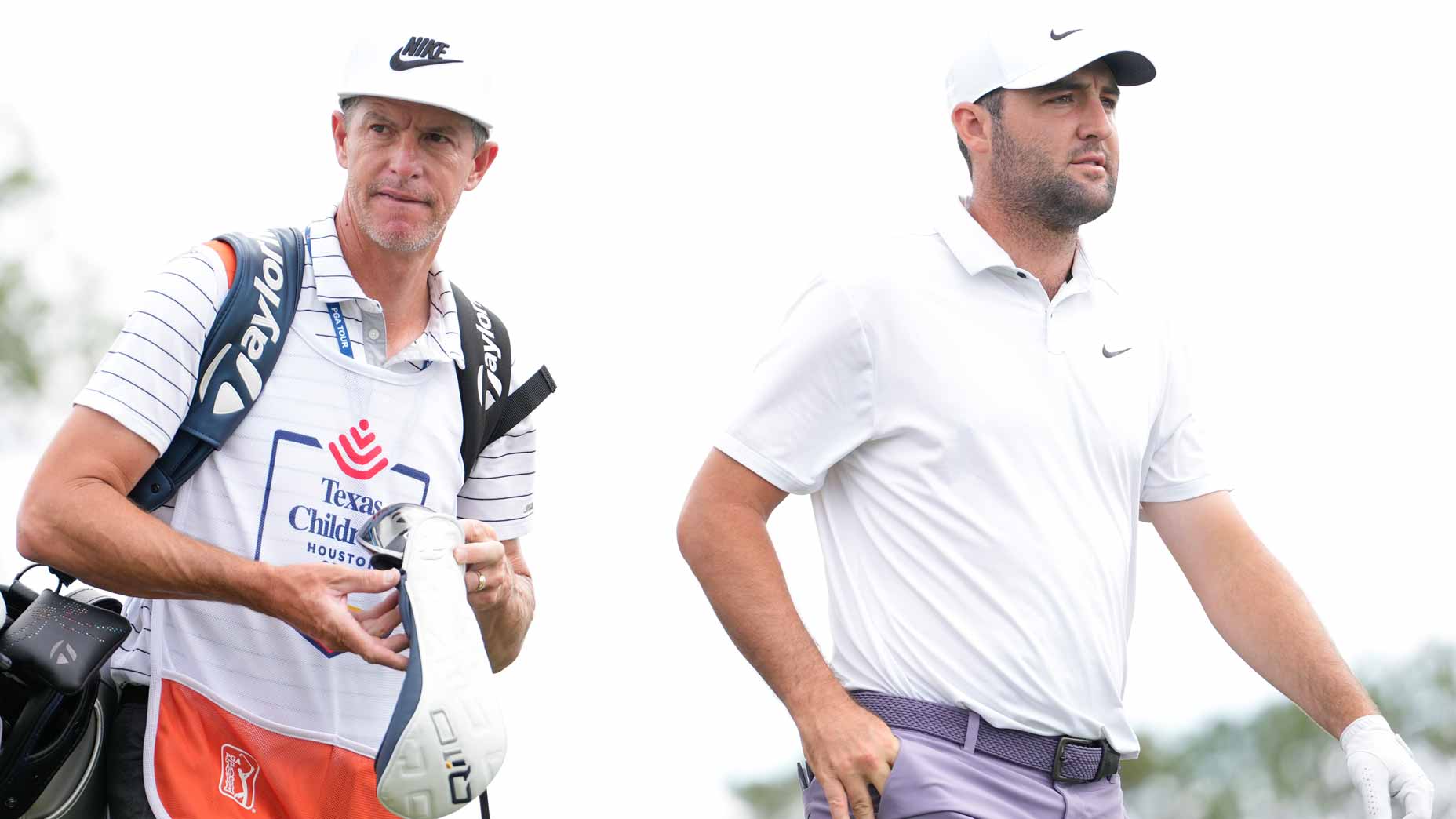 PGA Tour pro Scottie Scheffler and caddie Ted Scott walk during the Texas Children's Houston Open at Memorial Park Golf Course.