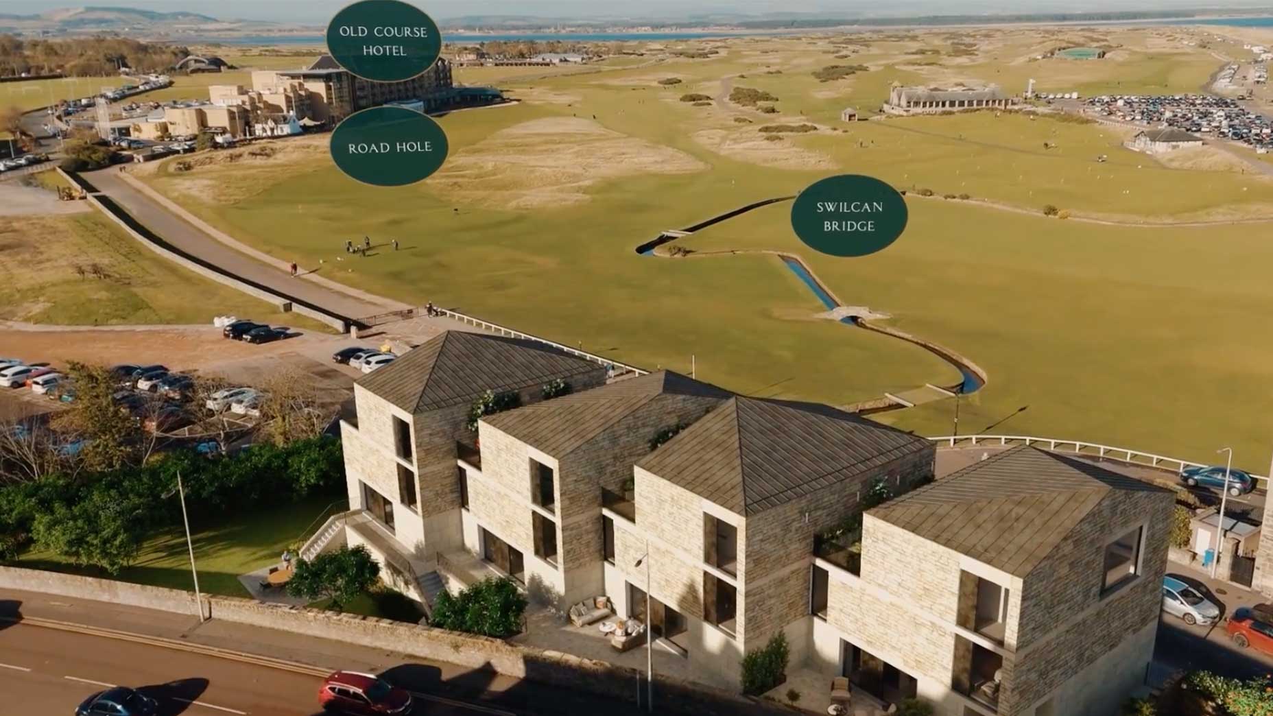 an overhead shot of a house on the old course at st andrews with swilcan bridge and the old course hotel in the background