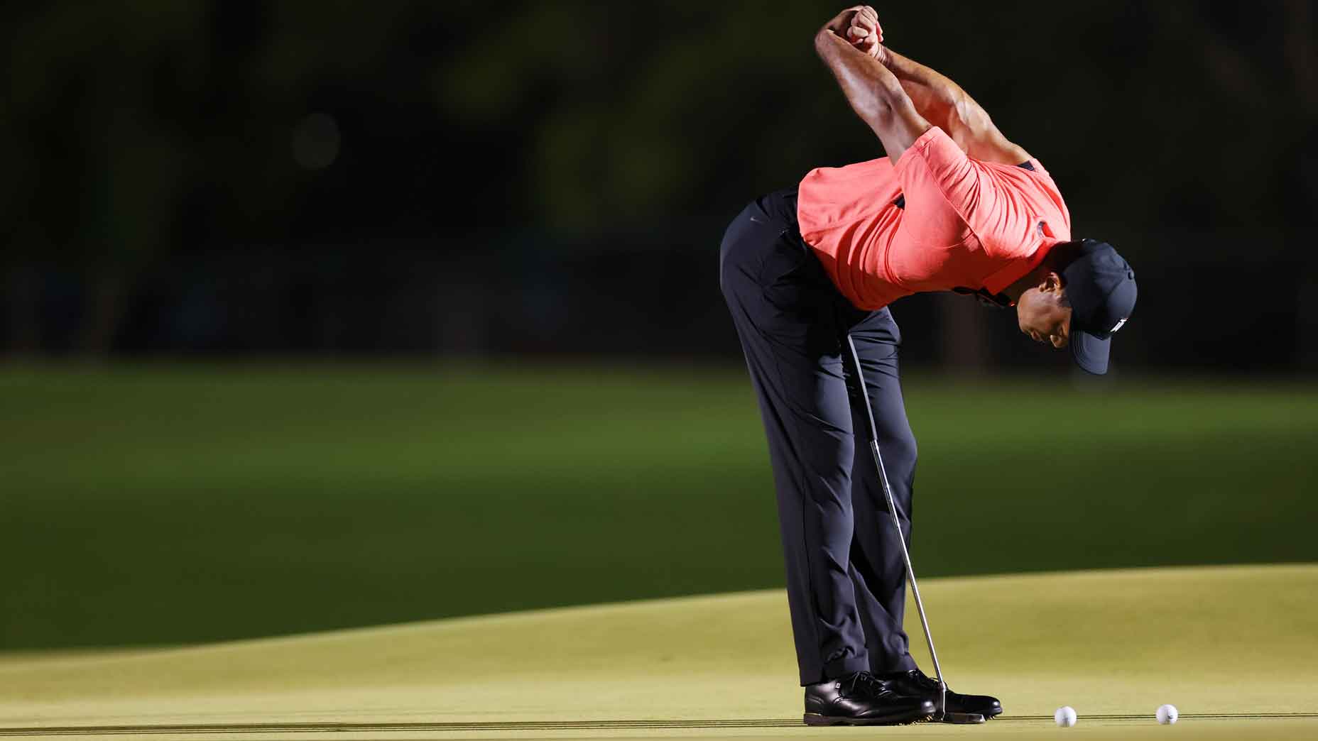 tiger woods stretches before the match 7 in 2022