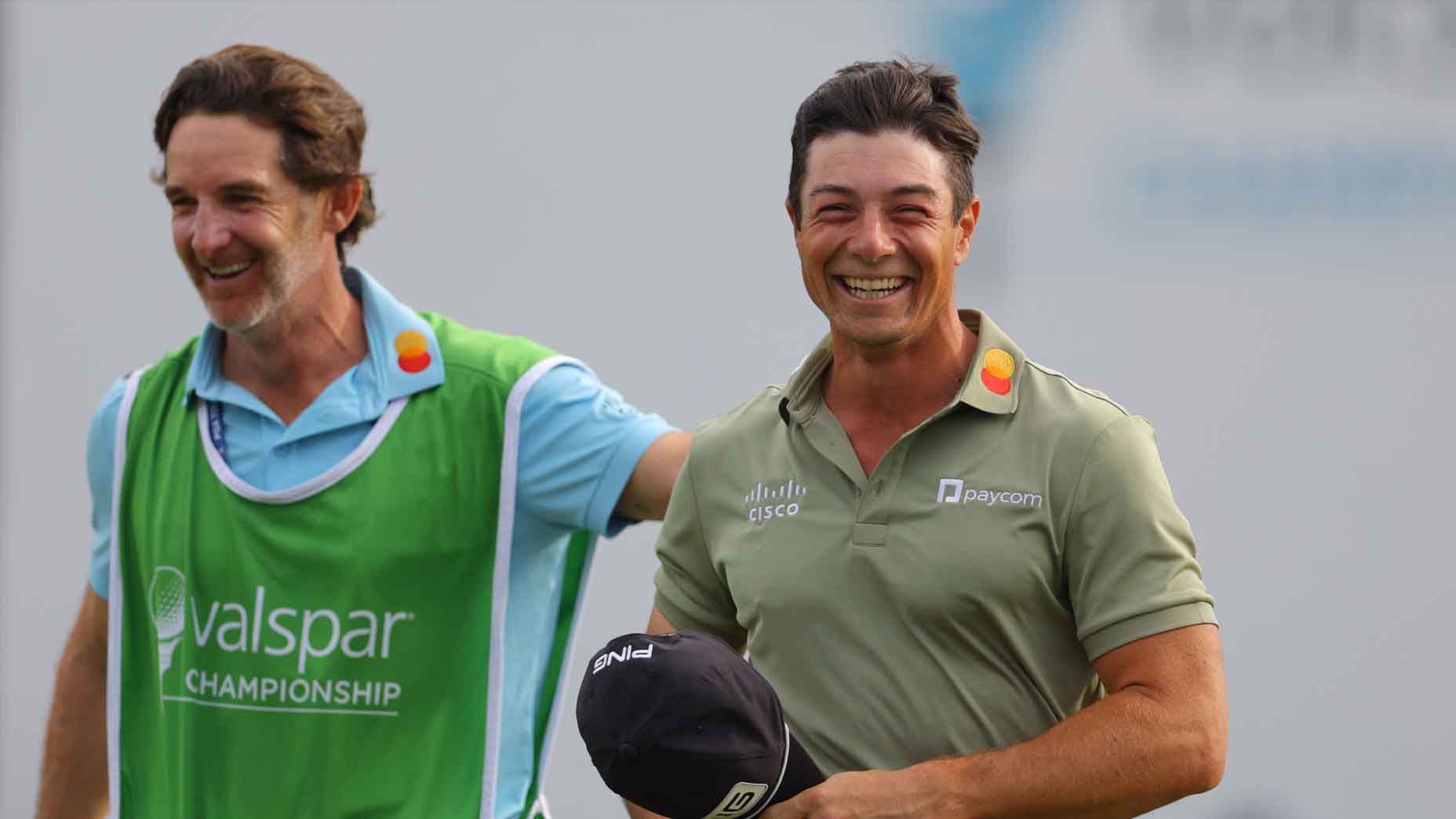 Viktor Hovland celebrates with his caddie after winning the 2025 Valspar Championship.