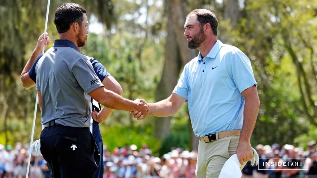 Scottie Scheffler and Xander Schauffele of the United States react on the 16th green prior to THE PLAYERS Championship on the Stadium Course at TPC Sawgrass