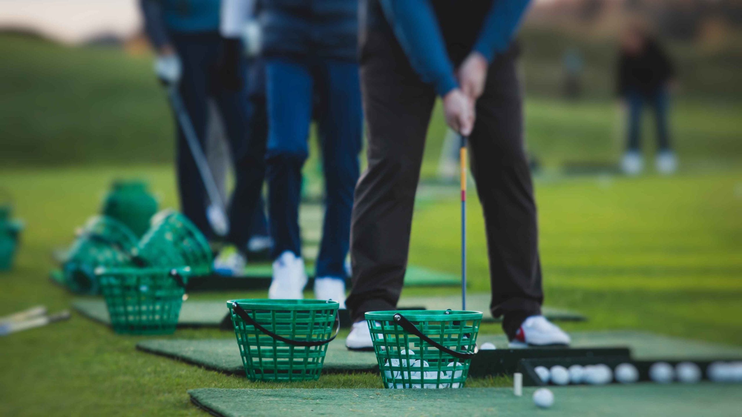 golfers lined up on driving range