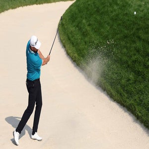 shane lowry hits out of a bunker at oakmont