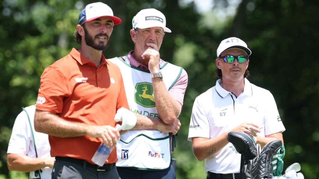 Rickie Fowler of the United States stands on the second tee with Max Homa of the United States and his caddie Lance Bennett during the second round of the John Deere Classic 2025 at TPC Deere Run on July 04, 2025 in Silvis, Illinois.
