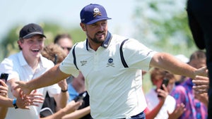 LIV pro Bryson DeChambeau high-fives fans during the 2025 LIV Golf Chicago tournament.