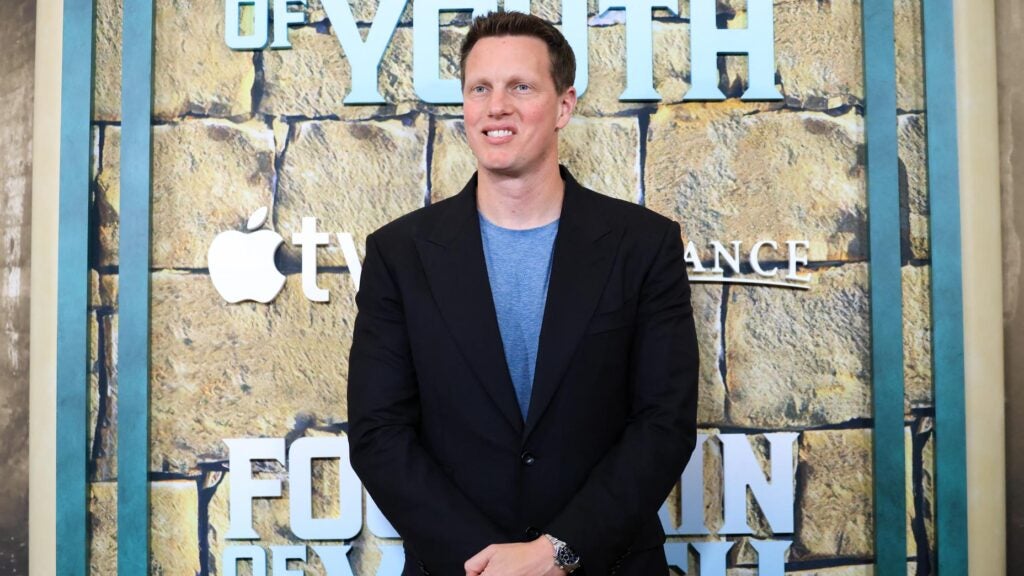 david ellison stands in a suit jacket and a t shirt