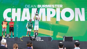 Dean Burmester (center) and Josele Ballester are pictured on the podium after the three-man playoff at LIV Golf Chicago.