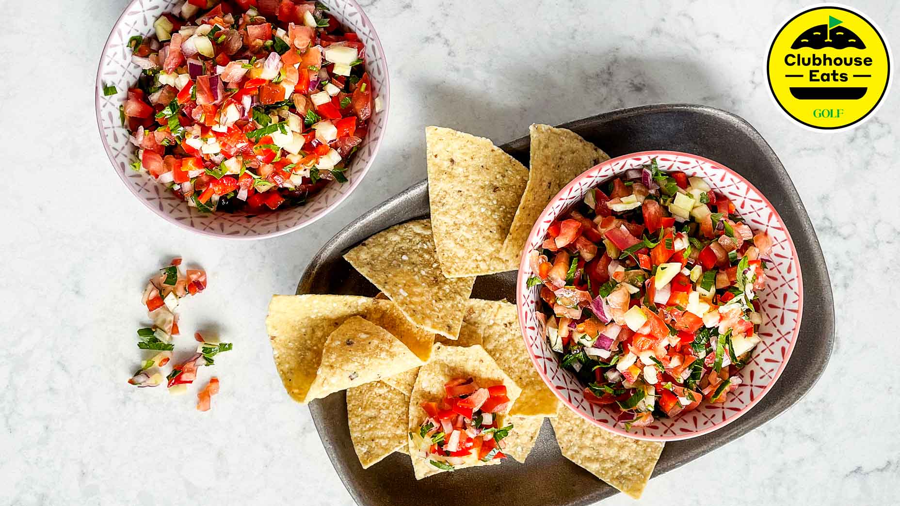 Two bowls of salsa with tortilla chips.