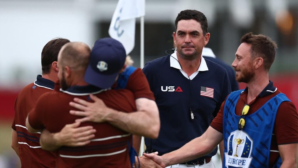 Captain Keegan Bradley of Team United States looks on after Matt Fitzpatrick and Tyrrell Hatton of Team Europe react