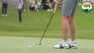 golfer in grey shorts hitts putt