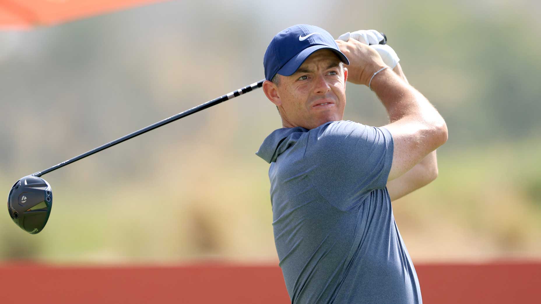 Rory McIlroy, betting favorite in the 2025 DP World Tour Championship odds, plays shot during the 2025 Abu Dhabi HSBC Championship.