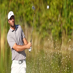 Scottie Scheffler hitting a bunker shot