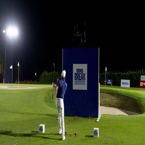 Rory McIlroy hits over 'Big Break' signage at the Optum Golf Channel Games.
