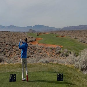Andrew Miller tees off on a golf course