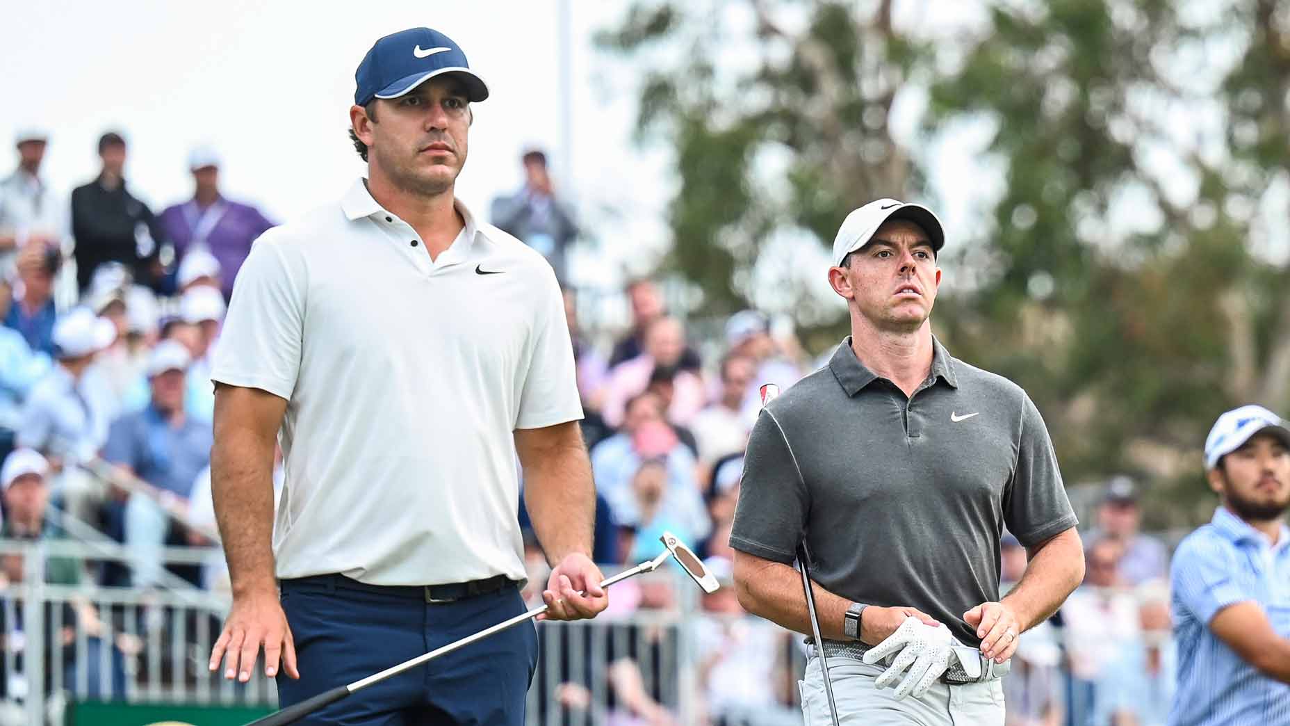 PGA Tour pros Brooks Koepka and Rory McIlroy walk off tee during the 2023 U.S. Open.
