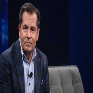 Derek Sprague looks on.