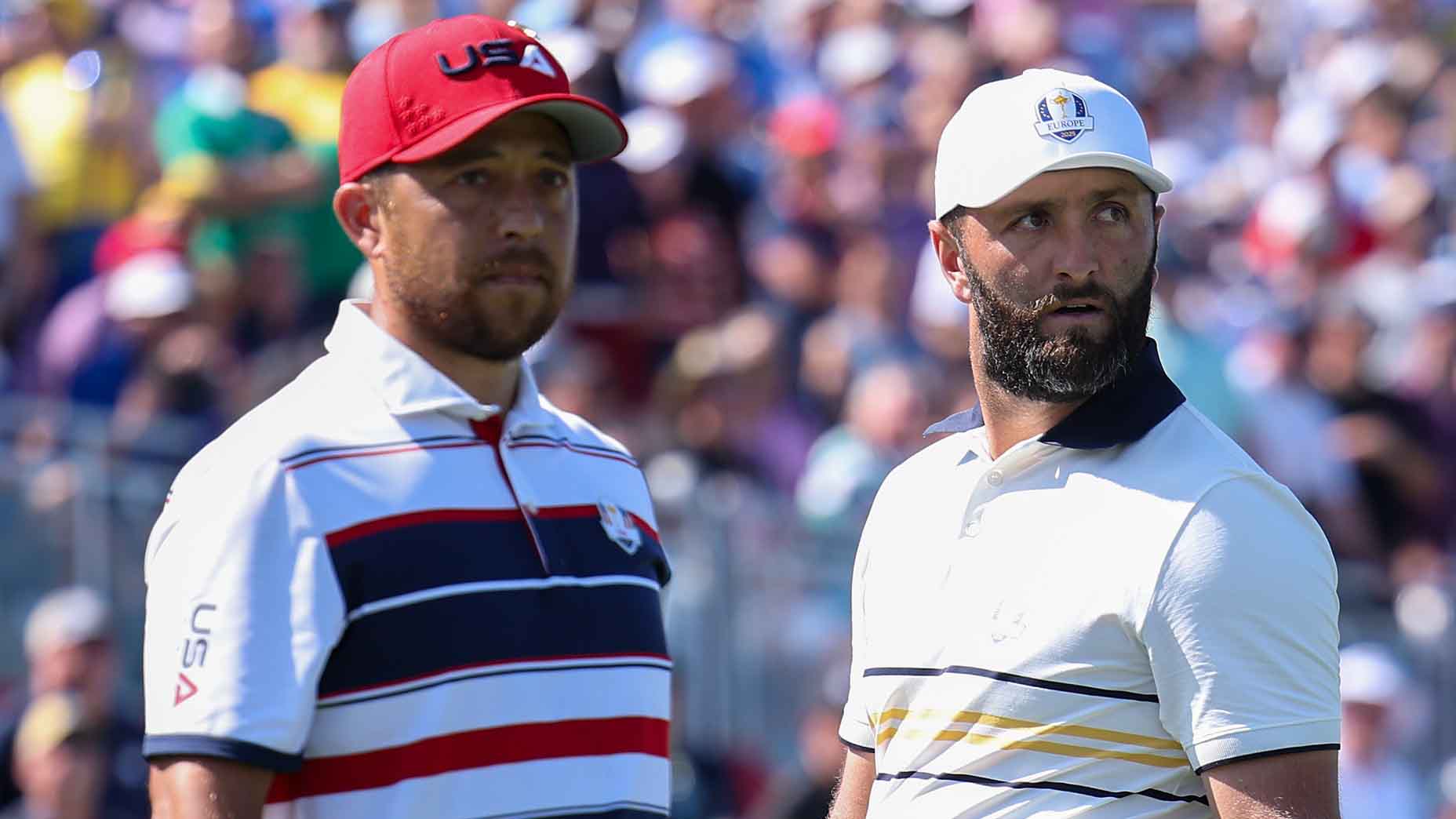 Jon Rahm and Xander Schauffele look on during the 2025 Ryder Cup