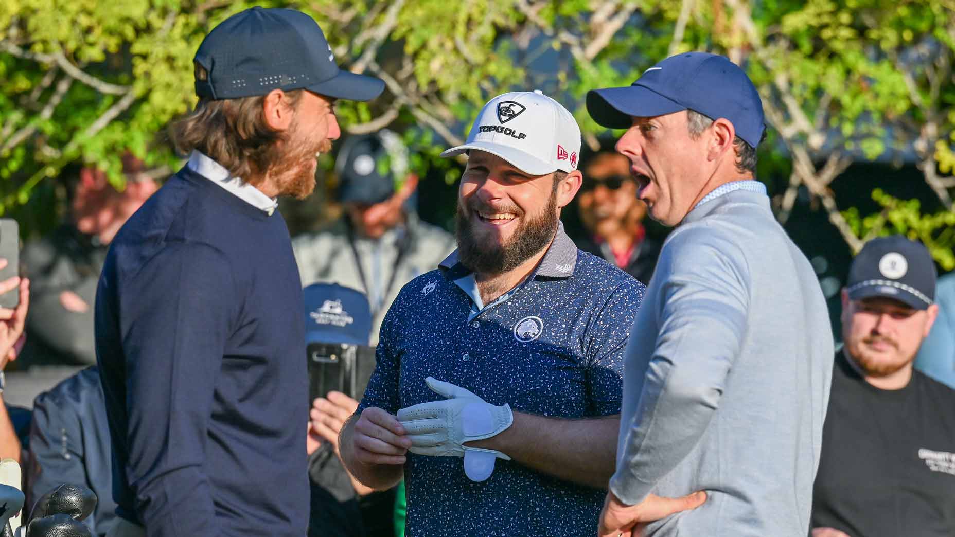 Tommy Fleetwood, Tyrrell Hatton and Rory McIlroy talk during the 2026 Hero Dubai Desert Classic.