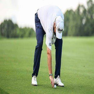 Shane Lowry of Ireland places his ball back down with preferred lies in effect on the 14th hole after heavy rainfall during the third round of the Travelers Championship at TPC River Highlands on June 22, 2024, in Cromwell, Connecticut. (