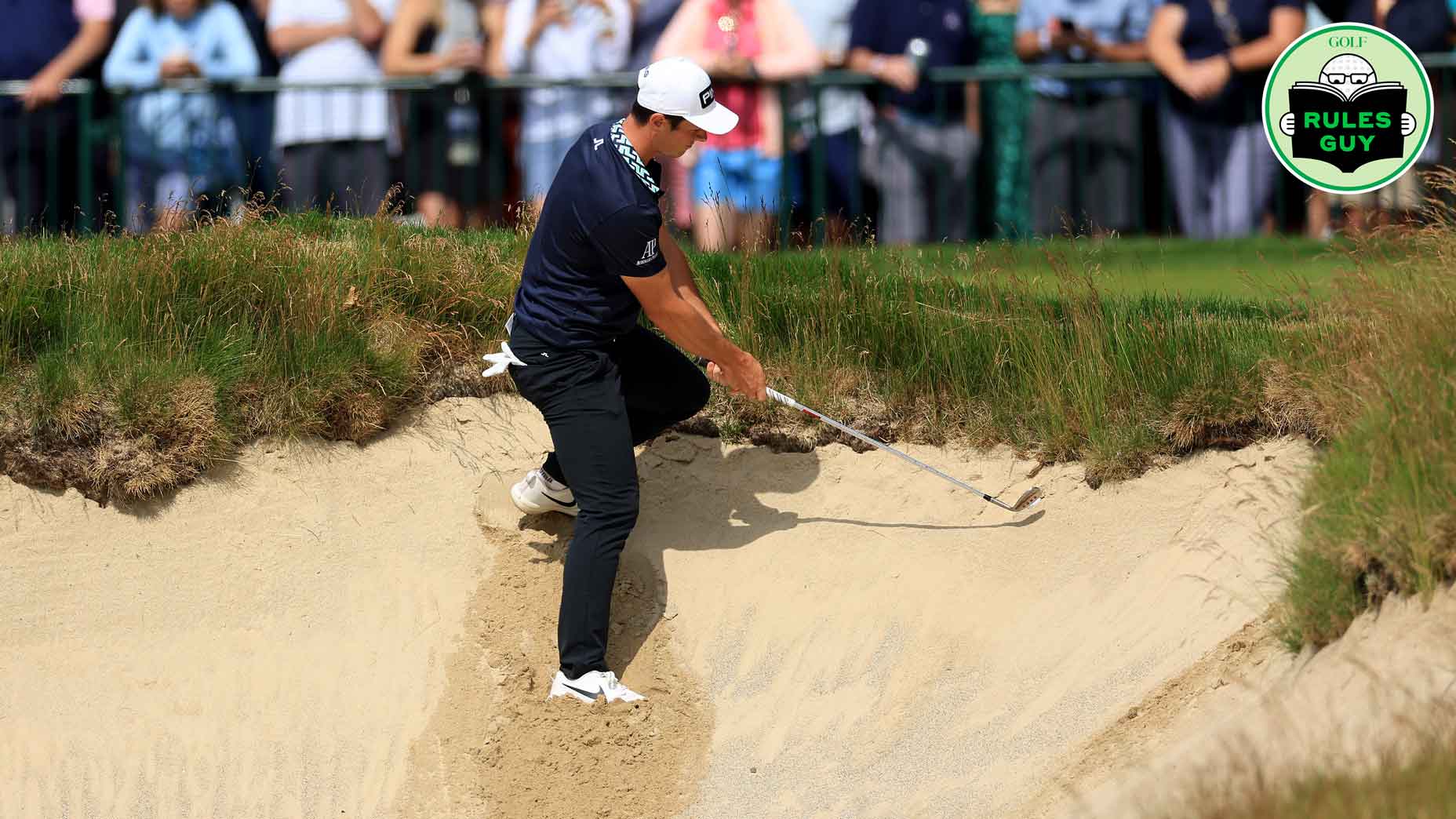 Viktor Hovland of Norway climbs into a bunker where his ball was plugged under the lip for his thir shot on the 18th hole during the second round of the 2022 U.S.Open Championship at The Country Club on June 17, 2022 in Brookline, Massachusetts. (Photo by David Cannon/Getty Images)