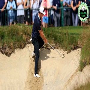 Viktor Hovland of Norway climbs into a bunker where his ball was plugged under the lip for his thir shot on the 18th hole during the second round of the 2022 U.S.Open Championship at The Country Club on June 17, 2022 in Brookline, Massachusetts. (Photo by David Cannon/Getty Images)