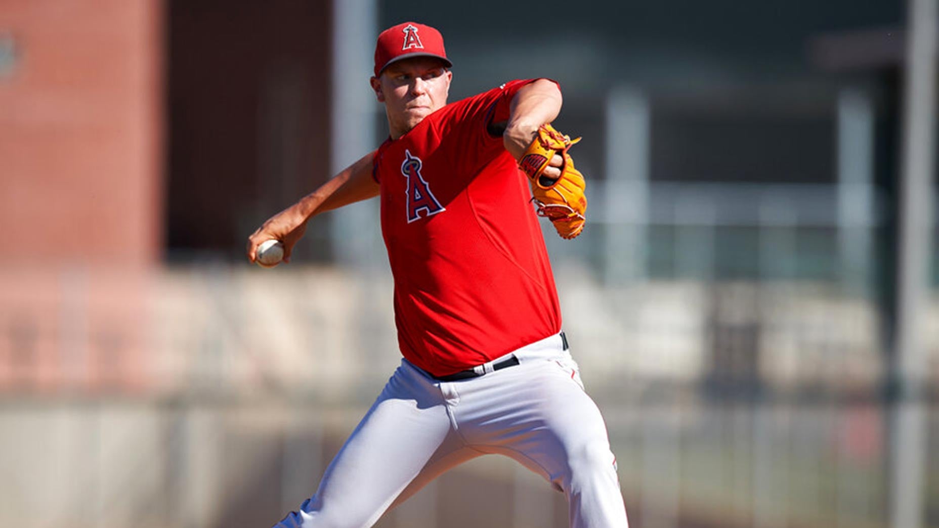 aaron cox throws a pitch in an angels uniform.