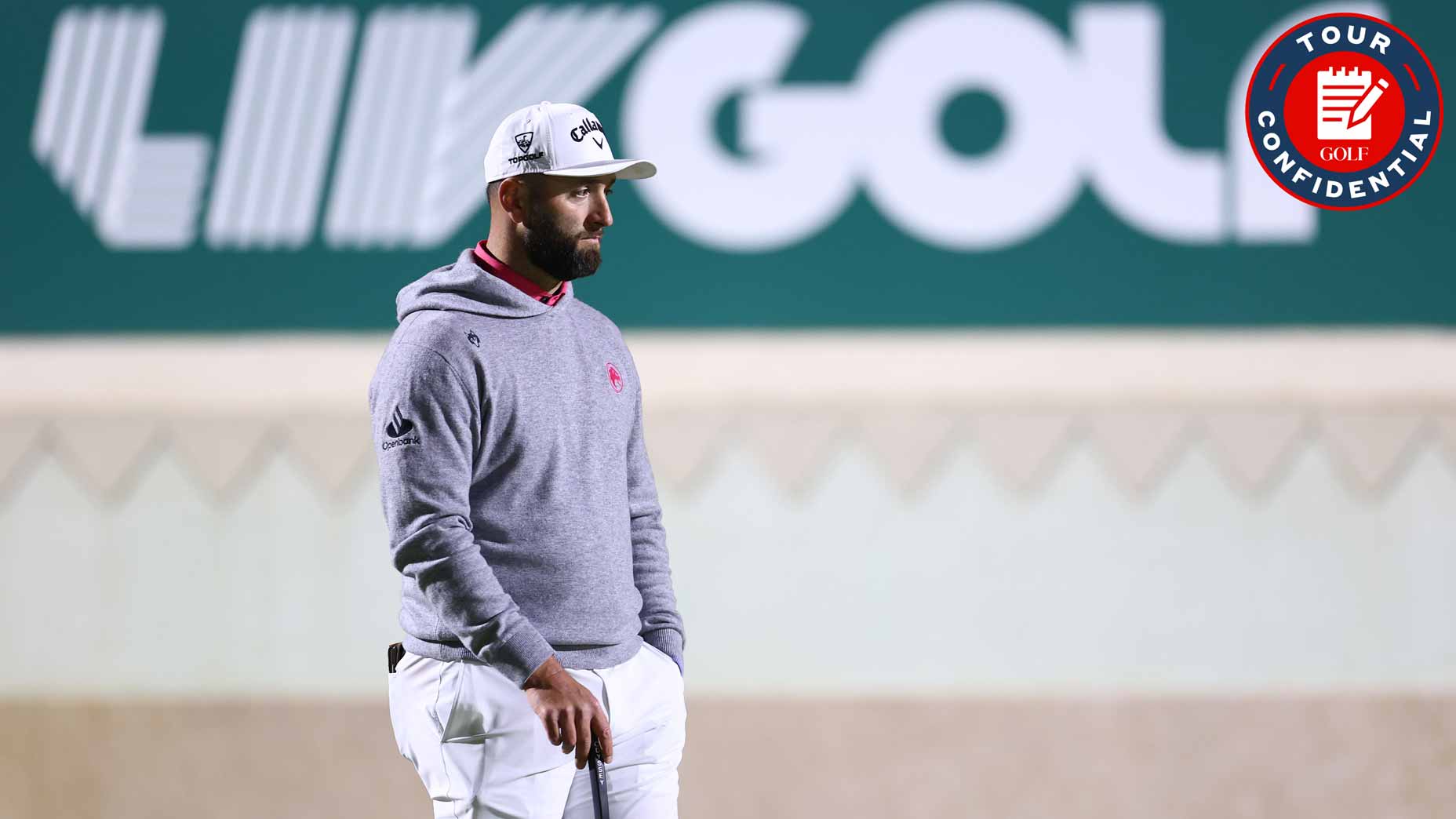 jon rahm stands in front of liv golf signage