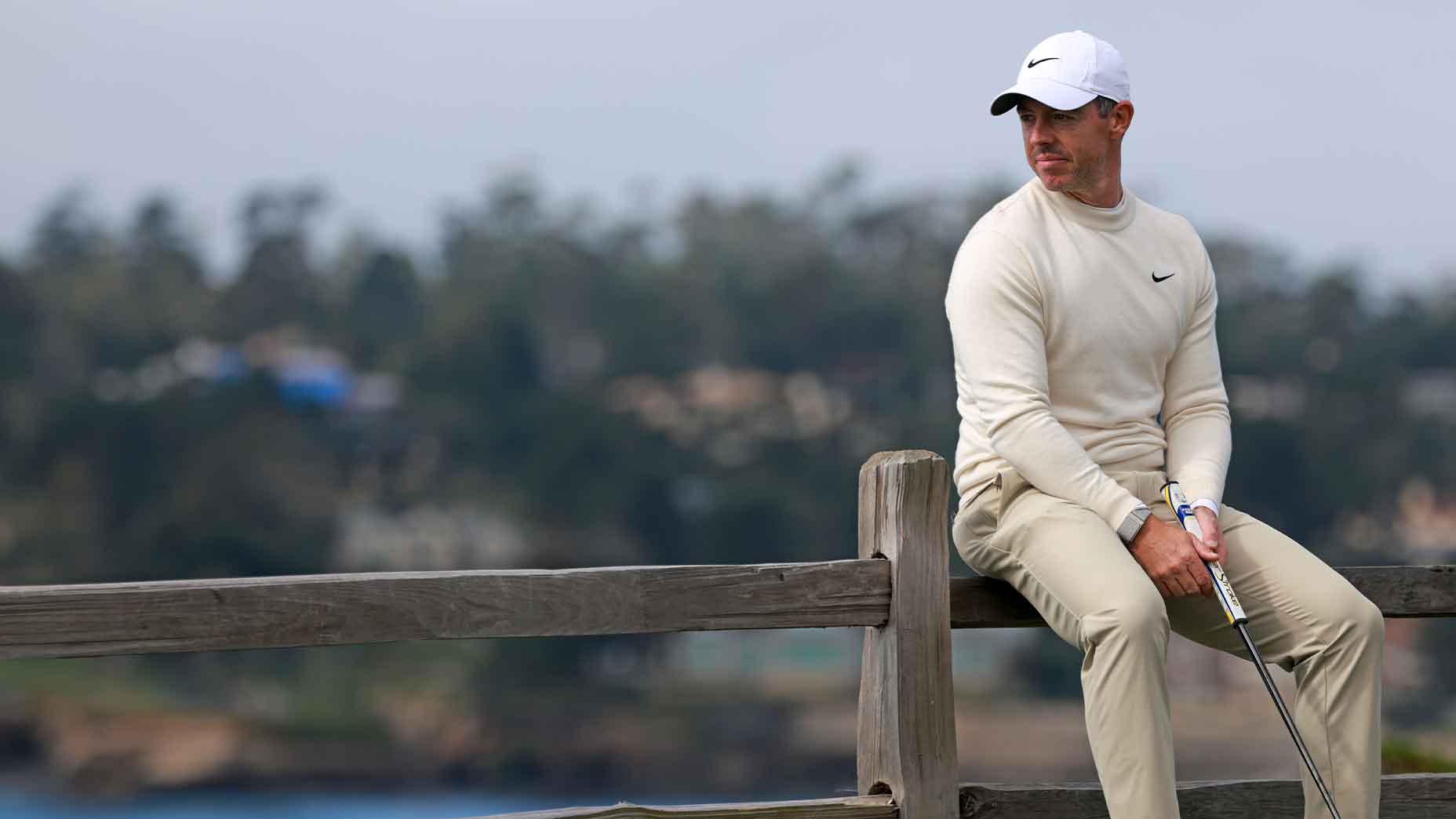 rory mcilroy sits on fence at pebble beach during att pebble beach pro-am