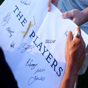 2026 Players Championship flag being signed by pros prior to Saturday at TPC Sawgrass.