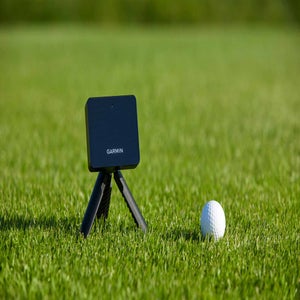 Garmin Approach R10 launch monitor on grass.
