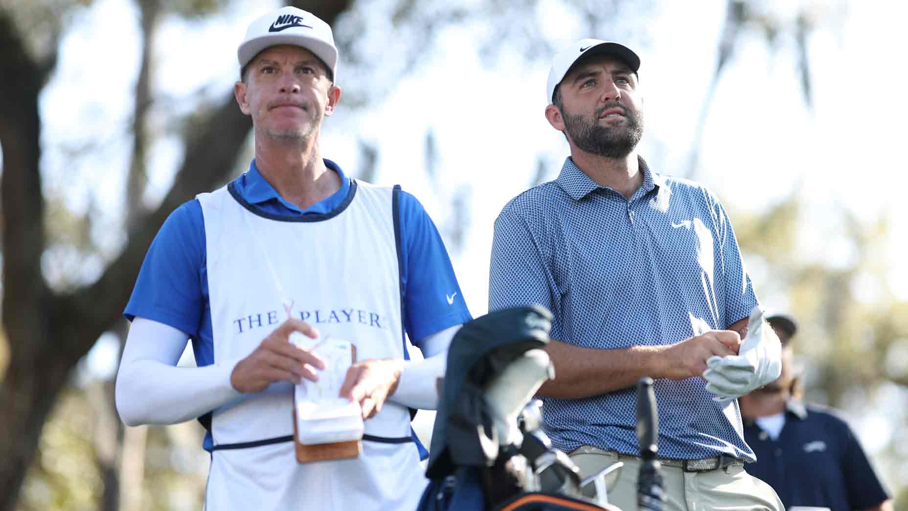 Scottie Scheffler of the United States prepares to play a shot from the 12th tee alongside caddie Ted Scott during the second round of THE PLAYERS Championship 2026 at THE PLAYERS Stadium course at TPC Sawgrass on March 13, 2026 in Ponte Vedra Beach, Florida. (Photo by Richard Heathcote/Getty Images)