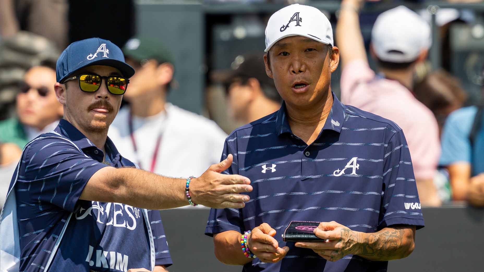 Anthony Kim taks to caddie during the 2026 LIV Golf Hong Kong event on Thursday.
