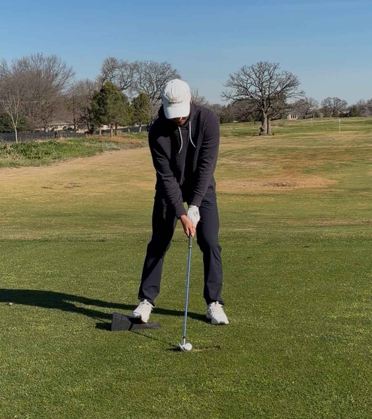 hudson weibel swings with wedge underneath his trail foot