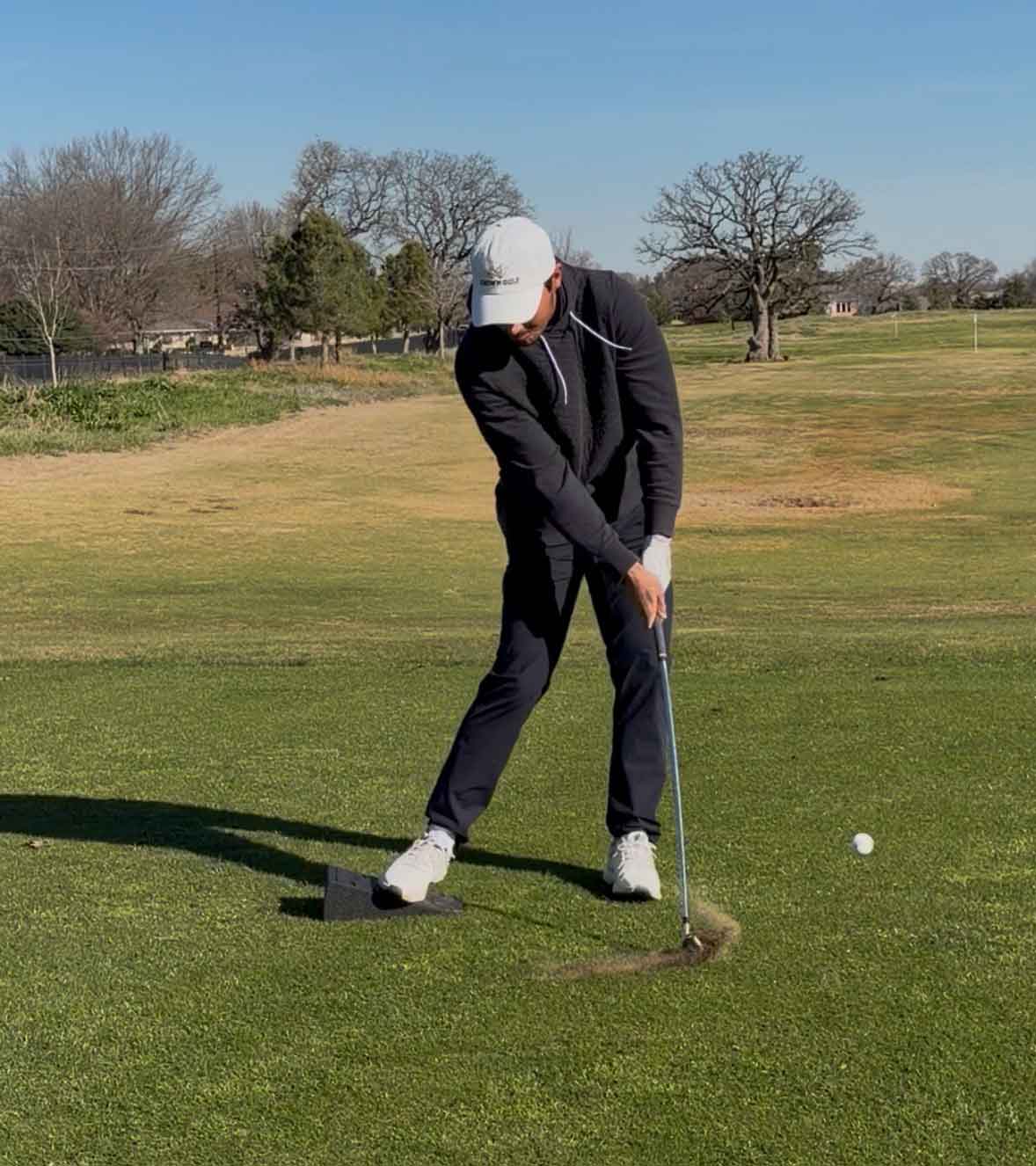 hudson weibel swings with wedge underneath his trail foot